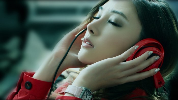 Asian girl listening to music with headphones