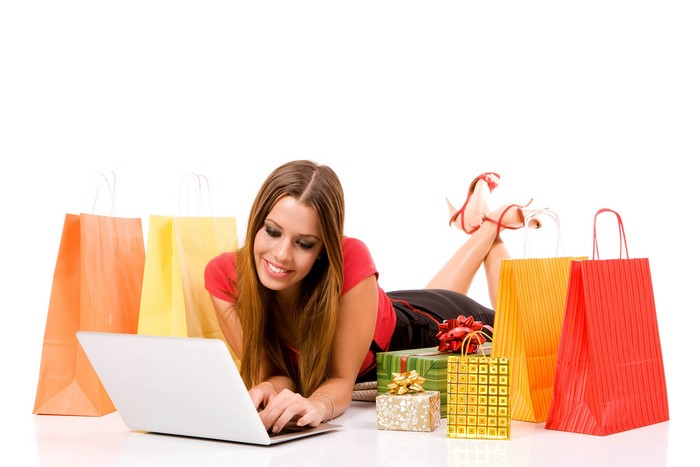 Girl with laptop and shopping bags