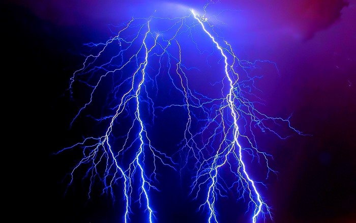 Striking Blue Lightning Bolts in Night Sky