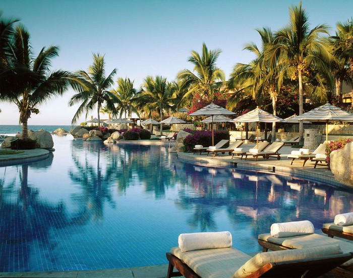 Tropical resort with infinity pool and palm trees