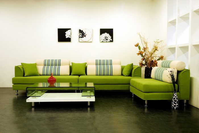 Modern living room with green sofa and glass coffee table
