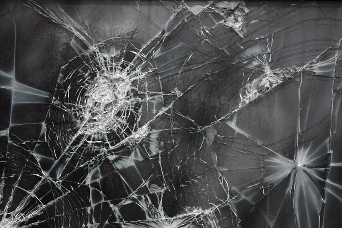 Close-up of shattered glass with radial cracks