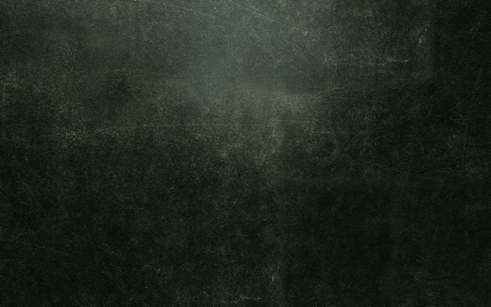 Dark gray textured surface with scratches