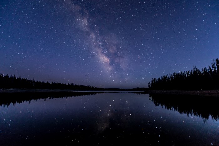 Milky Way over a reflective lake at night