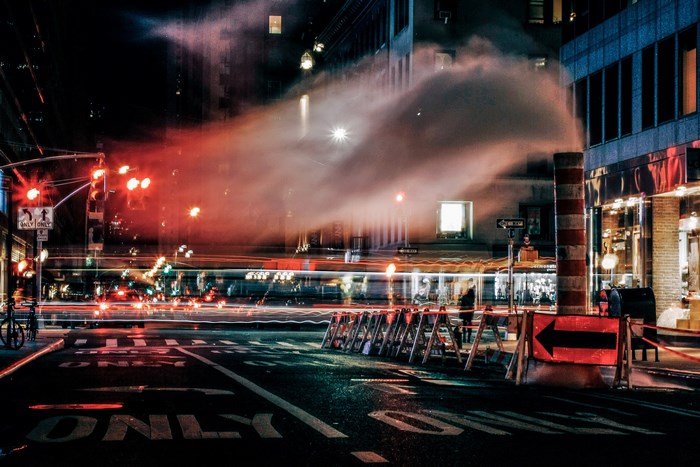 City street at night with steam and traffic lights