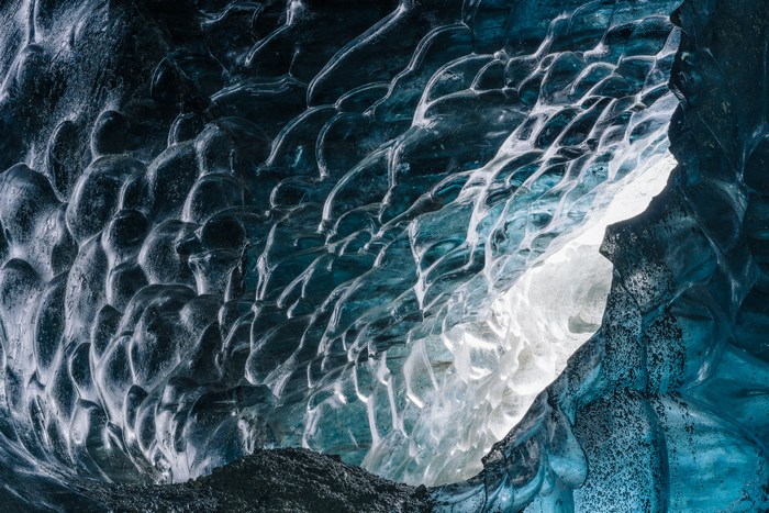 Inside an ice cave in Iceland with blue ice formations