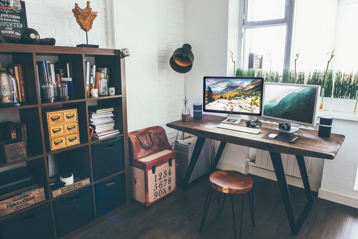Modern home office with dual monitors and wooden desk