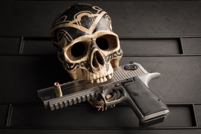 Skull with pistol and bullet