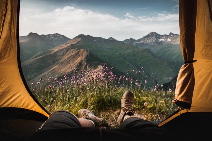 View from a tent of mountains and flowers