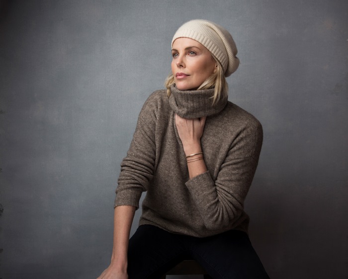 Charlize Theron wearing a beanie and sweater