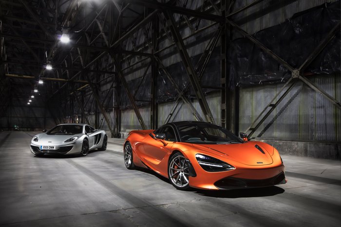 Two McLaren sports cars in a warehouse