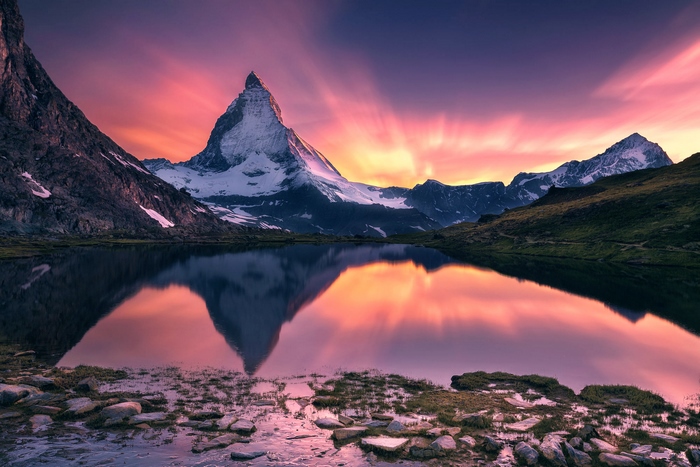 Matterhorn mountain reflected in a lake at sunset