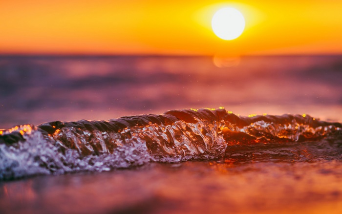Sunset over the ocean with waves