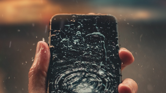Smartphone in the rain with water drops