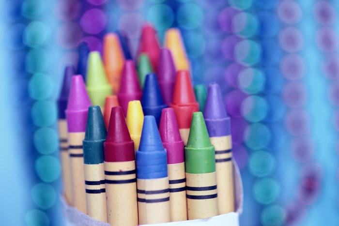 Close-up of colorful crayons in a box with bokeh background