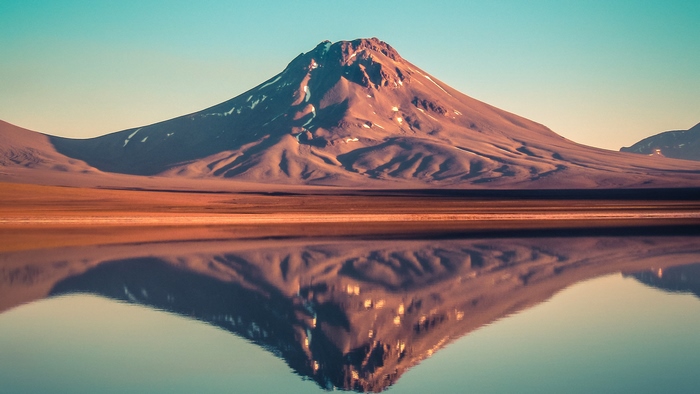 Mountain reflected in a calm lake at sunset