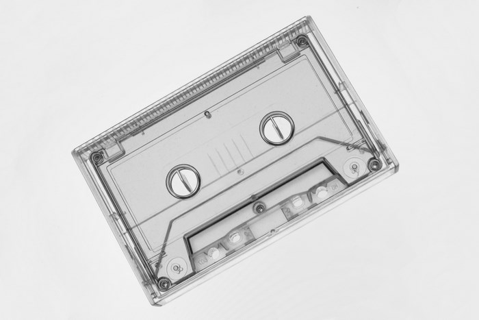 Transparent cassette tape with visible spools and tape