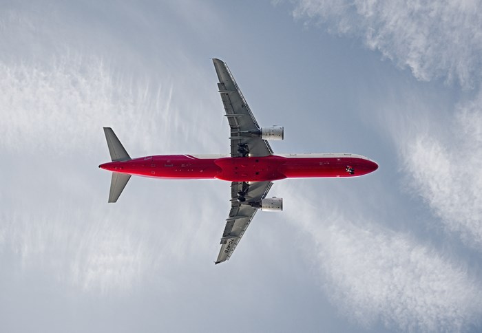 Red airplane flying in the sky