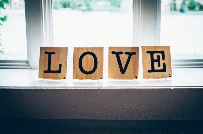 Wooden Scrabble Tiles Spelling LOVE on a Windowsill