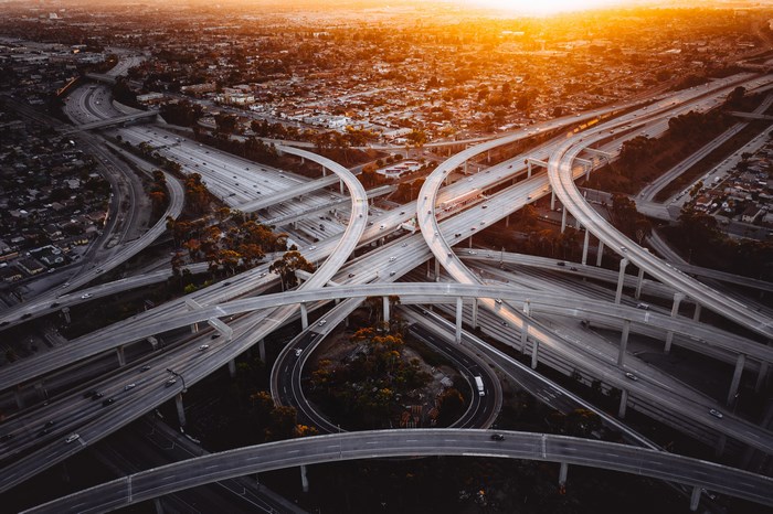 Aerial view of a complex freeway interchange at sunset