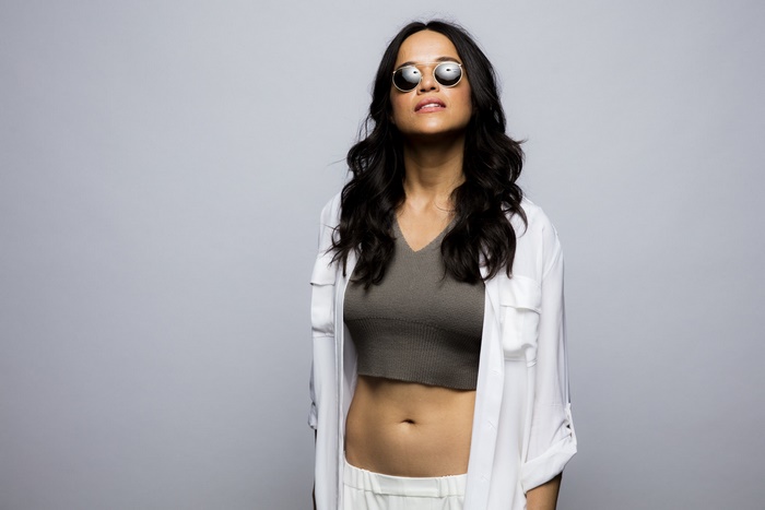 Michelle Rodriguez wearing sunglasses and a white shirt