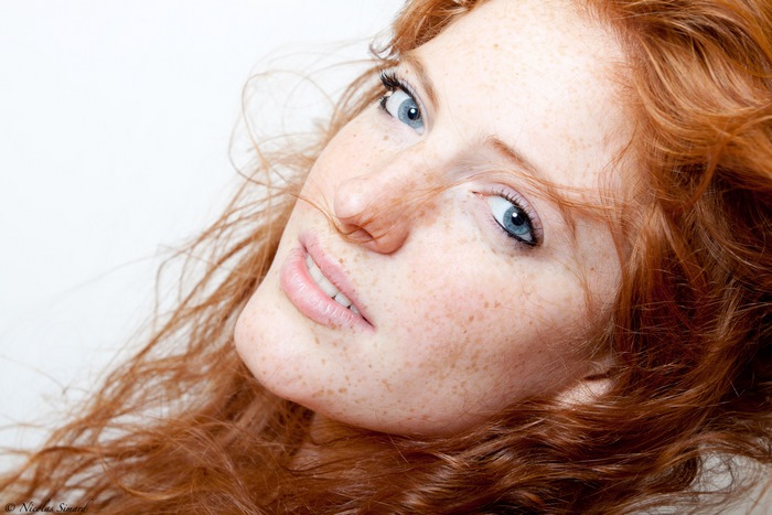 Woman with red hair and blue eyes and freckles