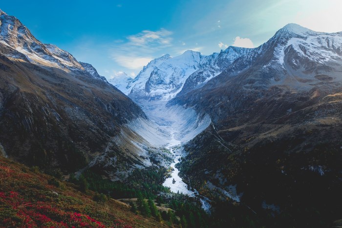 Snow-capped mountain range with a river flowing through a valley