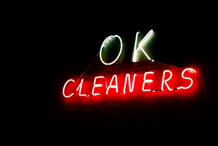 OK Cleaners neon sign at night