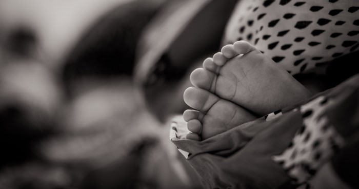 Black and white close-up of a baby's feet