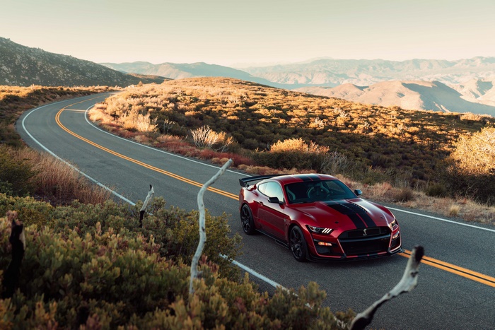 Red Ford Mustang Shelby GT500 on a mountain road