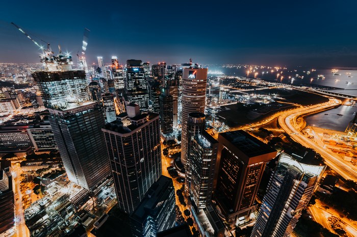 Singapore cityscape at night with busy harbor