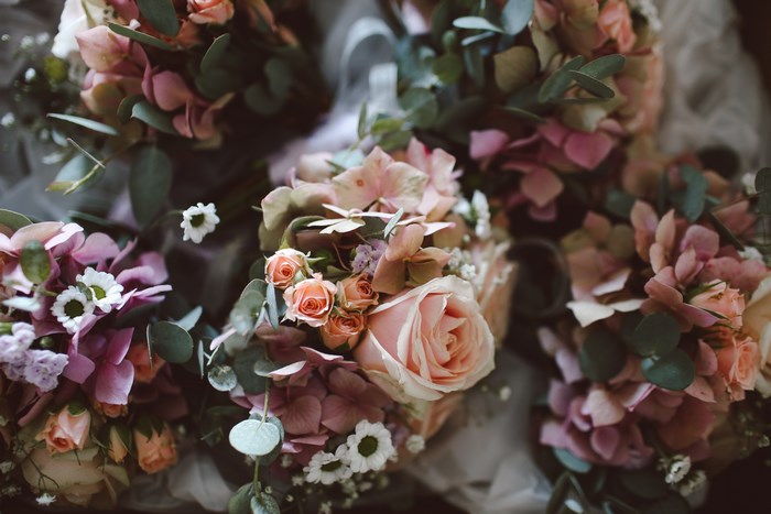 Pink and white floral bouquets with roses and daisies
