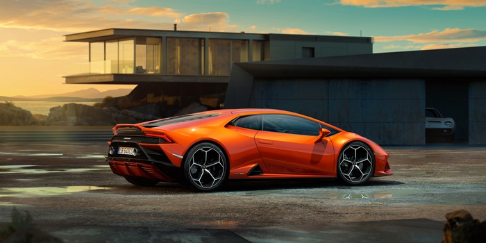 Orange Lamborghini Huracan parked by a modern house
