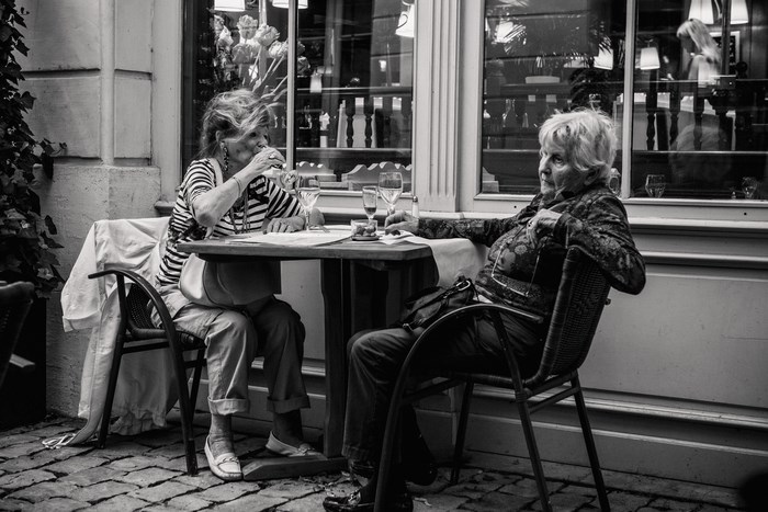 Two women dining at a restaurant table in Paris