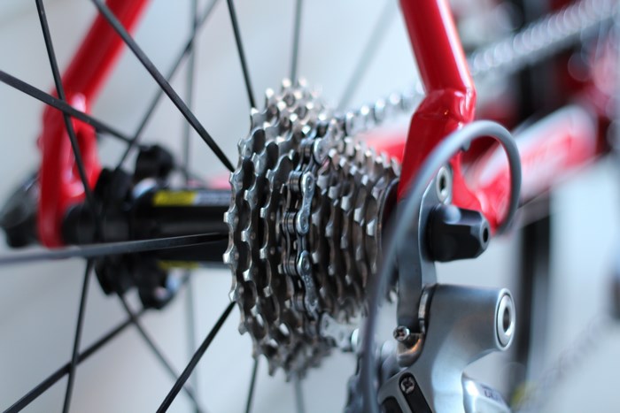 Close-up of a red bicycle rear derailleur and cassette