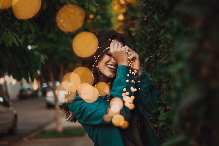 Woman smiling with fairy lights