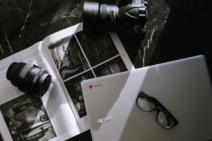 Nikon Camera, Acer Chromebook, and Photography Magazine