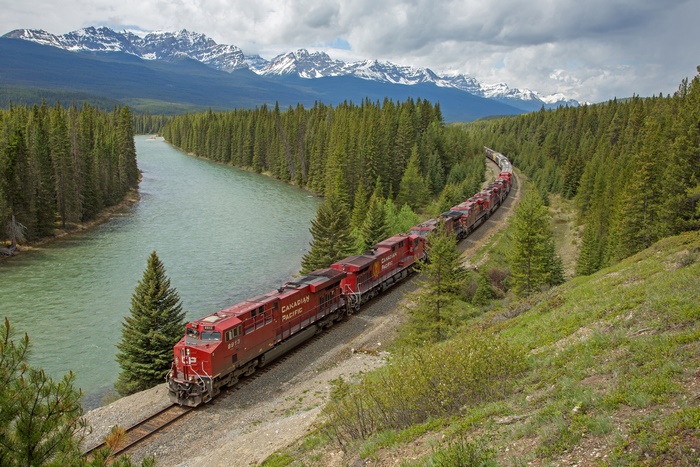 Canadian Pacific Train by River and Mountains