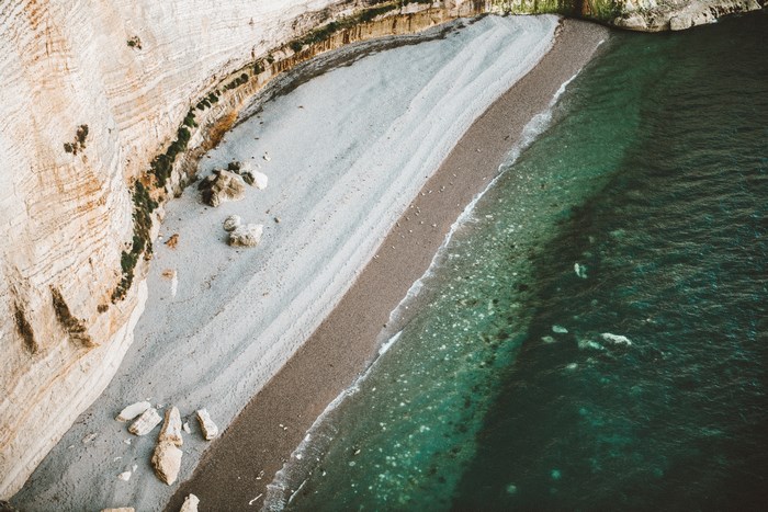 Aerial view of a rocky beach and turquoise ocean