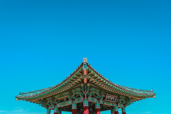 Traditional Korean Pavilion Roof Against a Blue Sky