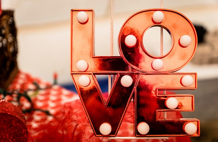 Red metallic "LOVE" marquee sign with lights