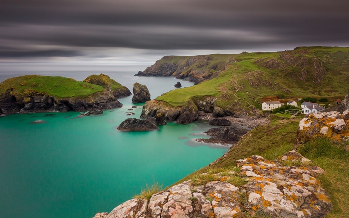 Coastal village with turquoise water and rocky cliffs