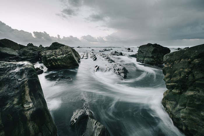 Long exposure of waves crashing on rocky coast