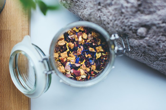 Top-down view of dried fruit and flower tea in a jar