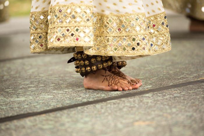Indian dancer's feet with bells and henna