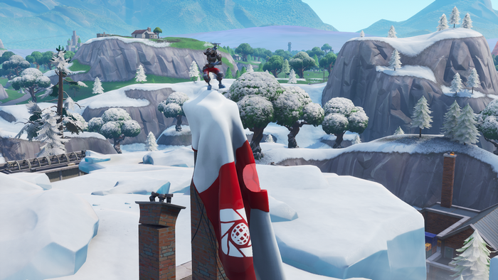 Fortnite character on snowy mountain with flag