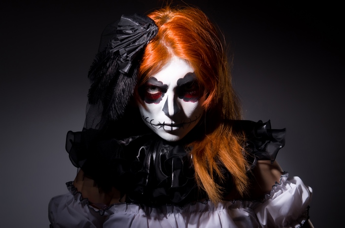 Woman with Sugar Skull makeup and orange hair
