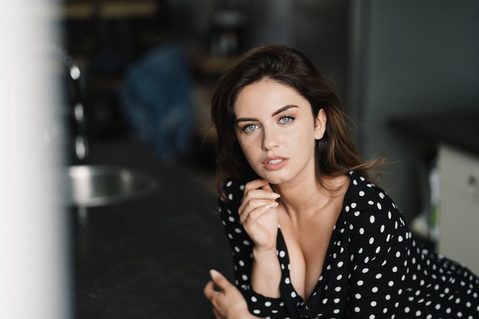 Woman with blue eyes in a polka dot dress