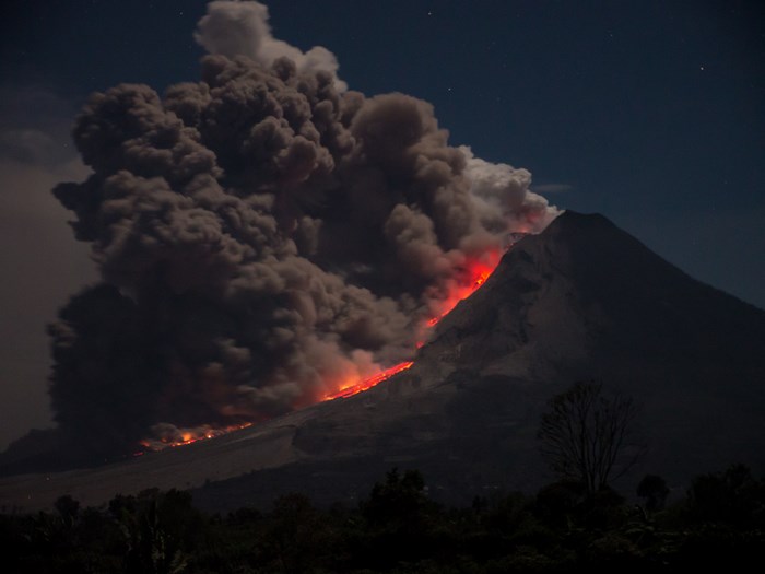Mount Sinabung eruption at night with lava and smoke