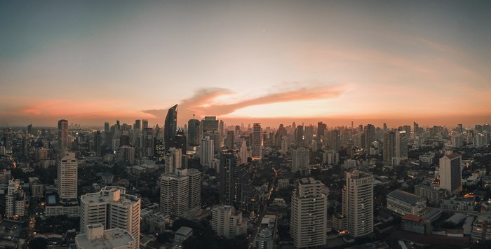Bangkok cityscape at dusk with orange sky